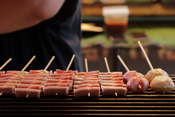 Thai-Asian style barbecue meatballs called 'Mala' served with a rich chili sauce, sold as street food.
