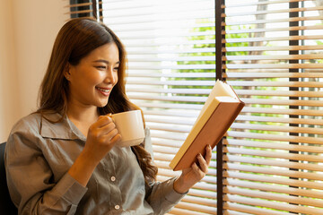 Woman enjoys book and music in modern abode.