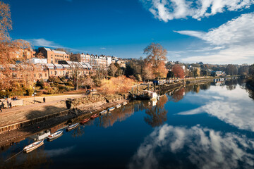 Beautiful view of rowboats moored in line on the River Thames on a cold day in late autumn, early winter in Richmond, Central London, England, UK