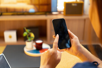 Woman enjoys book and music in modern abode.