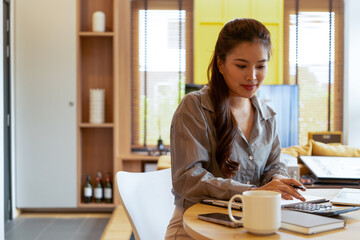 Woman enjoys book and music in modern abode.