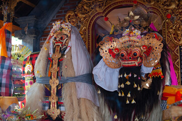Two sacred masks of Rangda and Barong at Hindu temple. Mythological demon queen and lion spirit. Symbol of good and evil balance in Balinese culture.