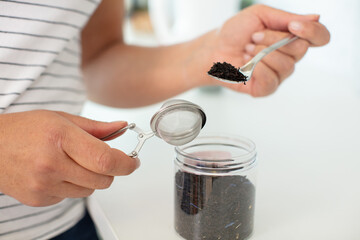 metal coffee measuring scoop on a woven straw background
