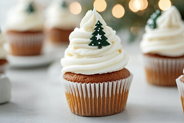 Spice christmas cupcake with tall white frosting, topped with a small green tree cutout decorated with white stars, against a blurred bokeh background. Charming holiday treat concept