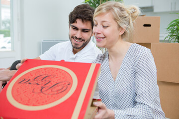 couple moving house eating pizza