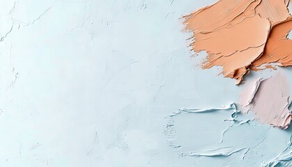 Close-up of makeup swatches in various shades on a textured, light blue surface, creating a visually appealing abstract composition with soft lighting.