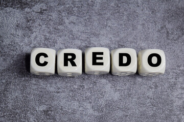 Obraz premium Credo text stacked wooden cubes on the table. Symbolizing core values and beliefs