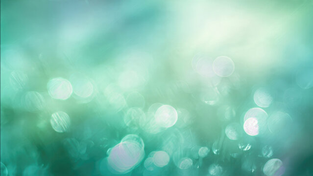 Ethereal bokeh lights create a dreamy, vibrant abstract background with soft teal, green, and blue hues, perfect for tranquil design.