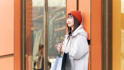 冬の街でショッピングをする女性