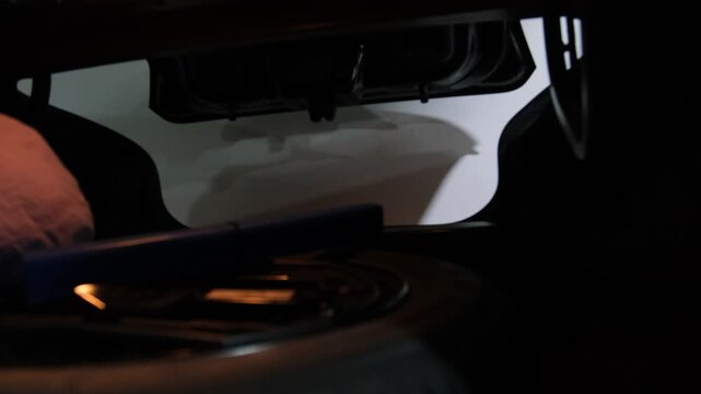 Remote key fob operating an automatic car trunk, opening the liftgate in a dark environment