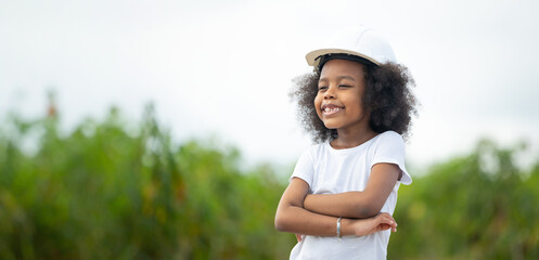 Engineer black girl Playing with Toy Wind Turbine in Wind Farm. Windmill. environmental renewable clean energy. Wind power generation. Nature Outdoor activitie. African American girl.