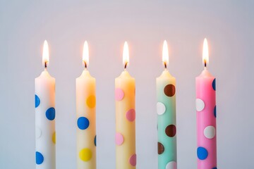 Colorful polka dot birthday celebration candles with warm glow