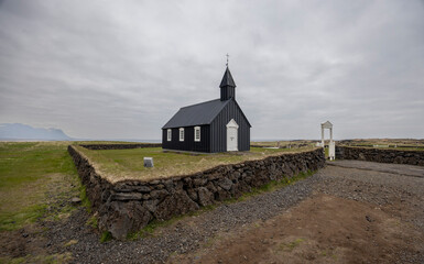 stone walls surrounding the grounds of the black wooden church, B&uacute;&eth;akirkja, Snaefellsnes, Iceland