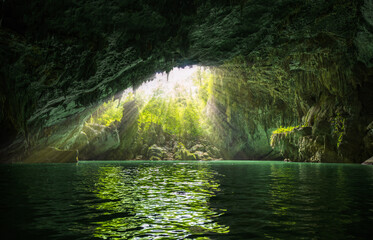 Sunlight Rays Streaming Into Bainiao Cave With Emerald Underground River in Guangxi China