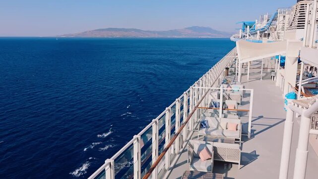 Open deck with cushioned seating glass railing bright sky clean surfaces minimal design and calm spacious atmosphere.