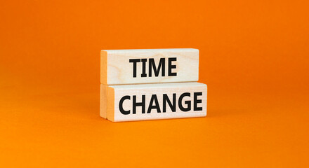 Time change symbol. Concept word Time change on beautiful wooden blocks. Beautiful orange paper background. Business time change concept. Copy space.