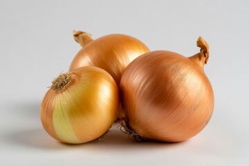Three golden onions isolated on white background