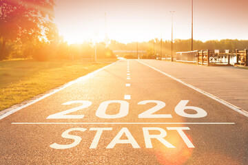 New year 2026 start concept idea. Number of the 2026 year is written on the asphalt on the empty path in sun rays. Concept of planning and vision. A direct path to the future. Motivational background