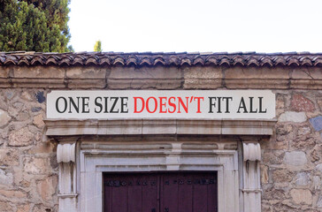 Fototapeta premium One size does not fit all symbol. Concept words One size does not fit all on beautiful white marble sign plate. Beautiful stone wall background. Business one size does not fit all concept. Copy space.