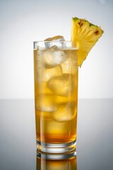 Refreshing iced cocktail with pineapple garnish isolated on white background