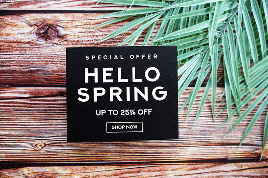 Hello Spring Sale 25% off with green leaf on wooden background Promotion Offer Discount Retail Shopping Concept