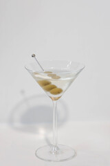 A refreshing martini glass garnished with olives