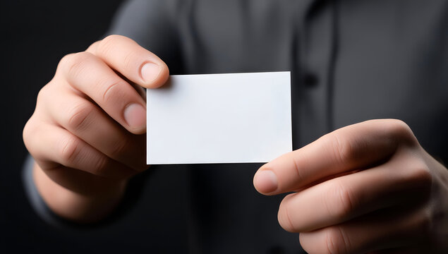 A person holding a blank business card, symbolizing opportunities and networking in the professional world.