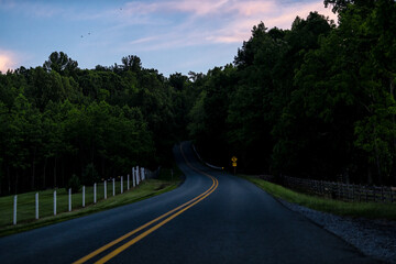 Countryside rural paved road in Lyndhurst, Virginia in beautiful evening dark night sunset at Reeds gap road in Blue Ridge mountains