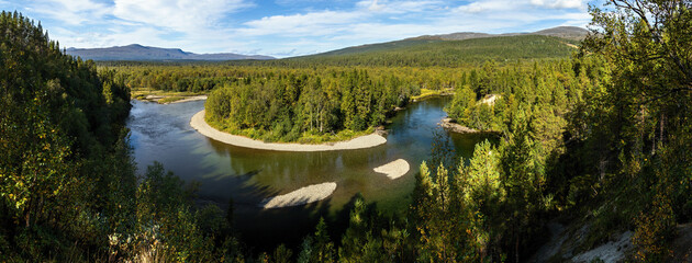 River meandering bends shore panorama green forest landscape in Vålådalen Sweden