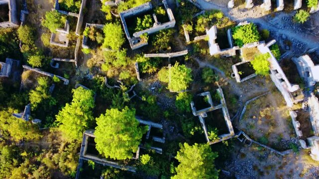 Kayakey, a historical ancient village in Fethiye, Turkey. A ghost town from a bird's-eye view. Ruins of an abandoned city on the Mediterranean coast.Lycia city, Carmassos.Dron.4K