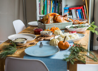 Thanksgiving dinner table with roasted turkey and festive dishes