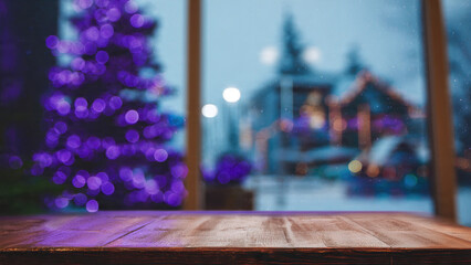 Rustic wooden table, blurred purple Christmas tree, and snowy festive lights through a window, creating a cozy winter holiday scene.