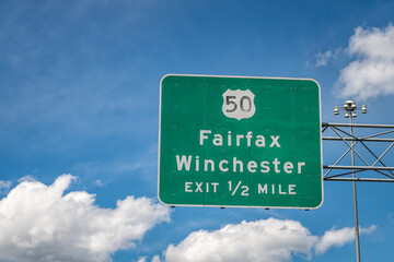 Sully road 28 multiple lane highway in Northern Virginia by Dulles Airport with Fairfax Winchester exit isolated sign against blue sky