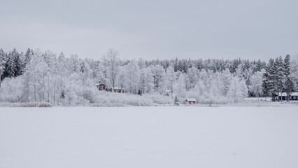 Farm barn and house in a cold and frosty morning in a wintry landscape