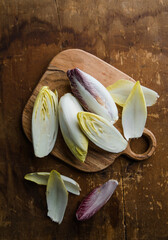 Group of fresh green Belgian endive or chicory and red Radicchio vegetables, also known as witlof...