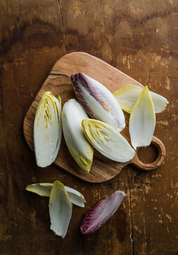 Group of fresh green Belgian endive or chicory and red Radicchio vegetables, also known as witlof salade