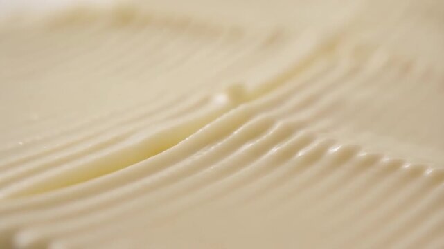 Creamy white texture with rippled lines creating a smooth, flowing effect perfect for baking or skincare product demonstration videos
