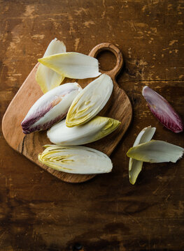 Group of fresh green Belgian endive or chicory and red Radicchio vegetables, also known as witlof salade