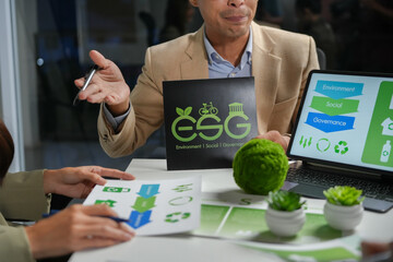 Business professionals analyzing the ESG report and strategy, focusing on environmental, social, and governance factors in a corporate meeting