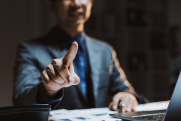 Businessman pointing finger, interacting with invisible screen for futuristic interface, driving innovation and digital transformation