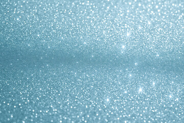 Abstract light blue glitter texture background with sparkling bokeh lights perfect for winter holidays and Christmas decoration
