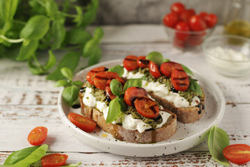 Italian sandwiches with grilled tomatoes, burrata cheese and pesto