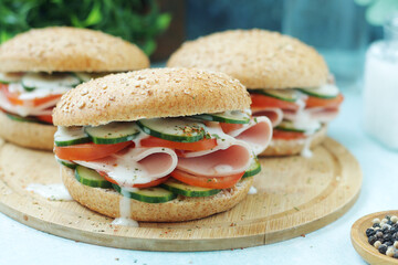 Bun sandwiches with salami and vegetables	