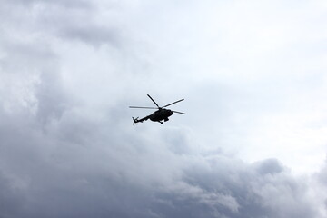 helicopter silhouette in the blue sky
