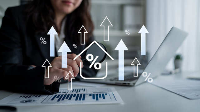 A businesswoman is analyzing market trends in a modern office. She uses a laptop and financial charts while focusing on growth indicators to drive success. Gantry