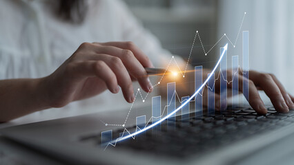 A business professional engages in financial analysis on a laptop, highlighting growth trends and statistics with digital overlays, symbolizing success and innovation. Scalp