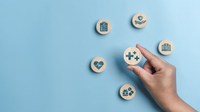 Healthcare and health insurance concept. Health insurance benefits, medical expenses and financial security. Healthcare, medical and health insurance icons on circle wooden blocks. Copy space.