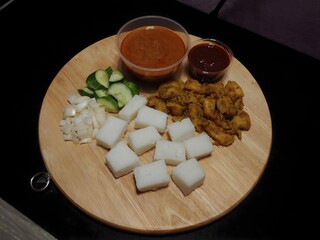 Grilled Stickless Chicken Satay served with Rice Cakes, Sambal and Peanut Sauce.