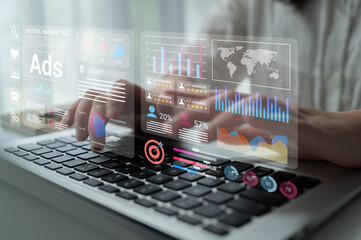 A professional analyzing digital marketing data on a laptop showcases interactive graphics and charts, highlighting key performance metrics and strategies. Gantry
