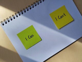 Hand written message can or can't with morning light from the window as self esteem building concept